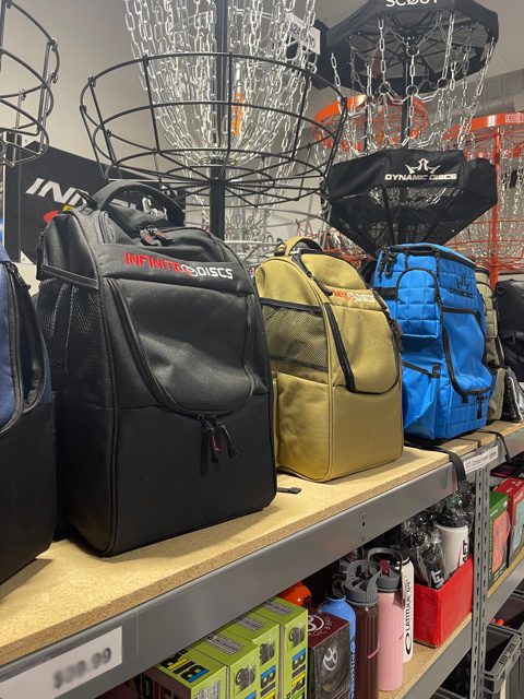 A selection of backpack bags in a disc golf shop