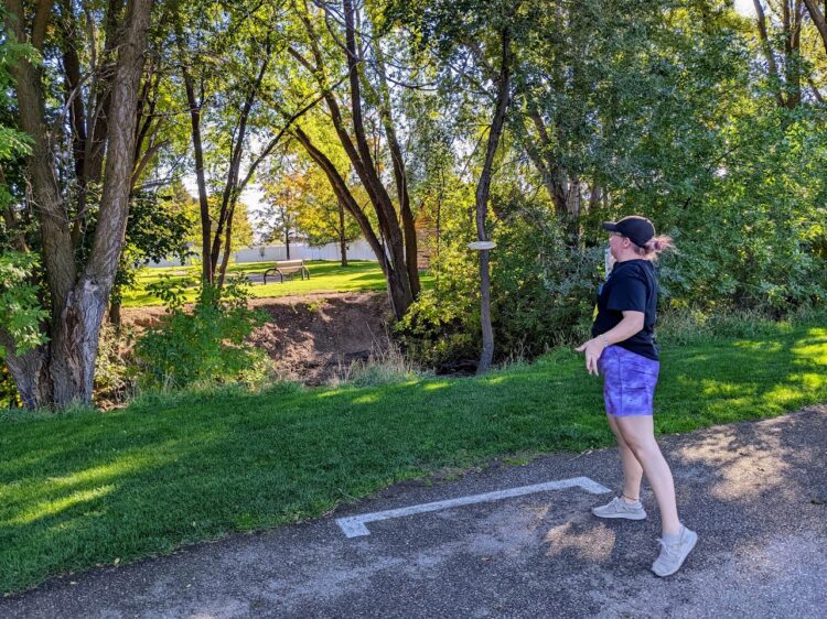 Beginner Disc Golfer Driving off the tee