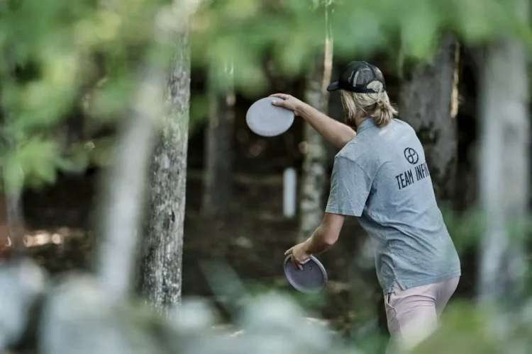 Pro Disc Golfer throwing max weight disc