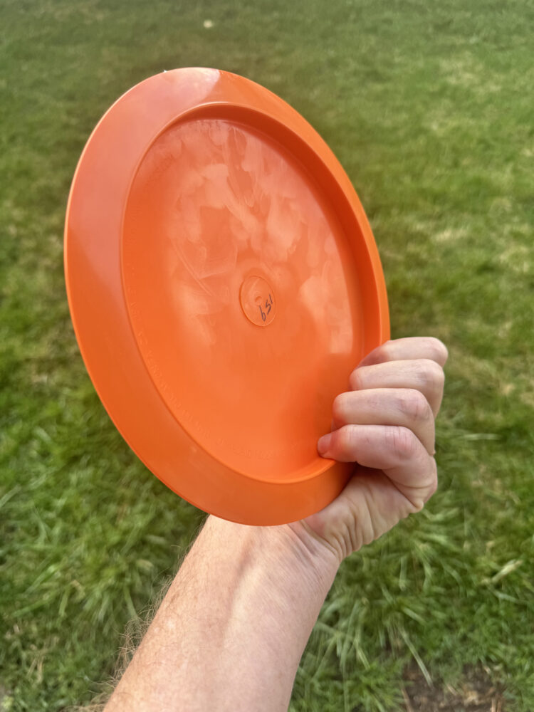 picture of an orange disc golf disc