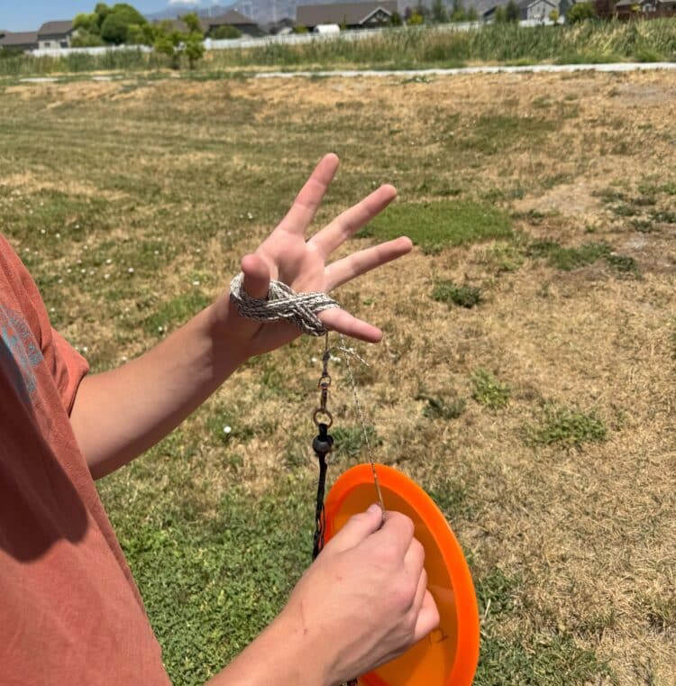 disc golfer storing a hyzerline disc golf ttrainer