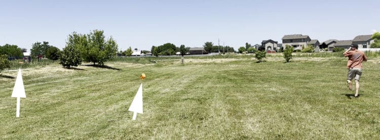 Disc golfer using a Hyzerline disc golf trainer