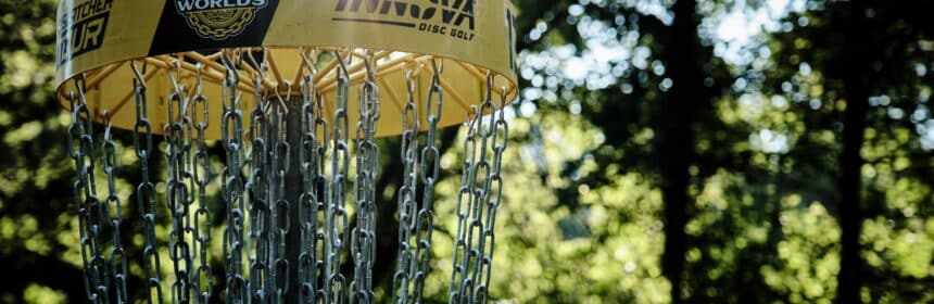 A disc golf basket on a course