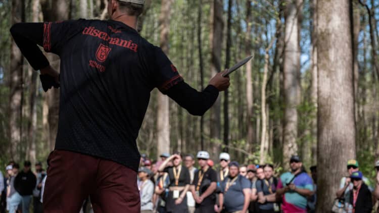 A professional disc golfer preparing to throw a disc.